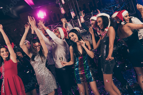 Photo of festive pretty people new year meeting falling confetti hold wineglass alcohol dance floor modern club indoors