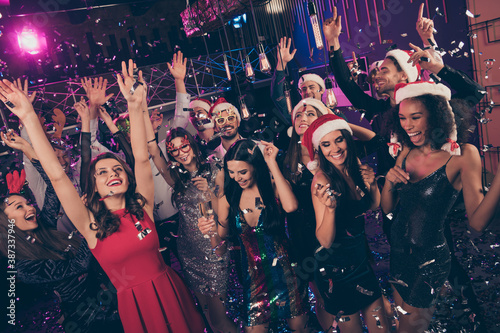 Photo of beautiful people laugh hold glass falling sparkles raise hands dance floor modern club indoors