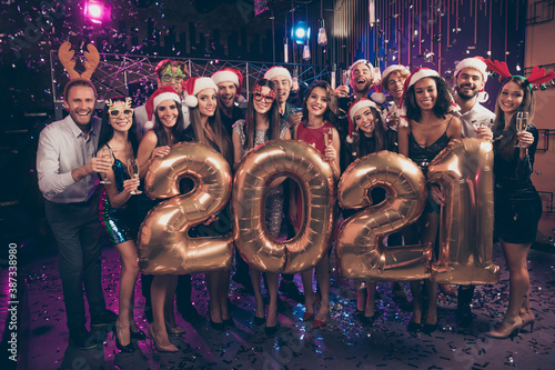 Photo portrait of happy group with 2021 balloons at new year party wearing reindeer hats santa caps glasses confetti