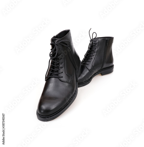 Fashionable black boots for men and women isolated on white background © Elena