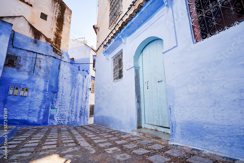 Public pedestrian street in old town Medina of Chefchaouen, Morocco. Chefchaouen or Chaouen is known that the houses in this city are painted in blue. © luengo_ua