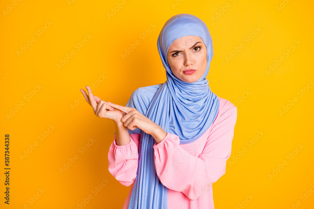 Portrait of attractive mad displeased muslimah wearing hijab blaming counting pretense isolated on bright yellow color background Portrait of attractive mad displeased muslimah wearing hijab blaming counting pretense isolated on bright yellow color background