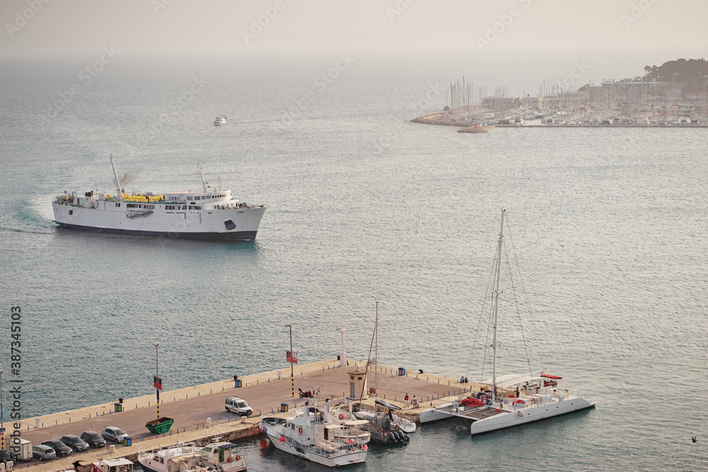 Big white ferry ship entering Adriatic harbor.
