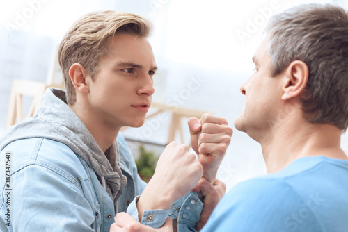 Adult son repels dad who raises his hands on him.
