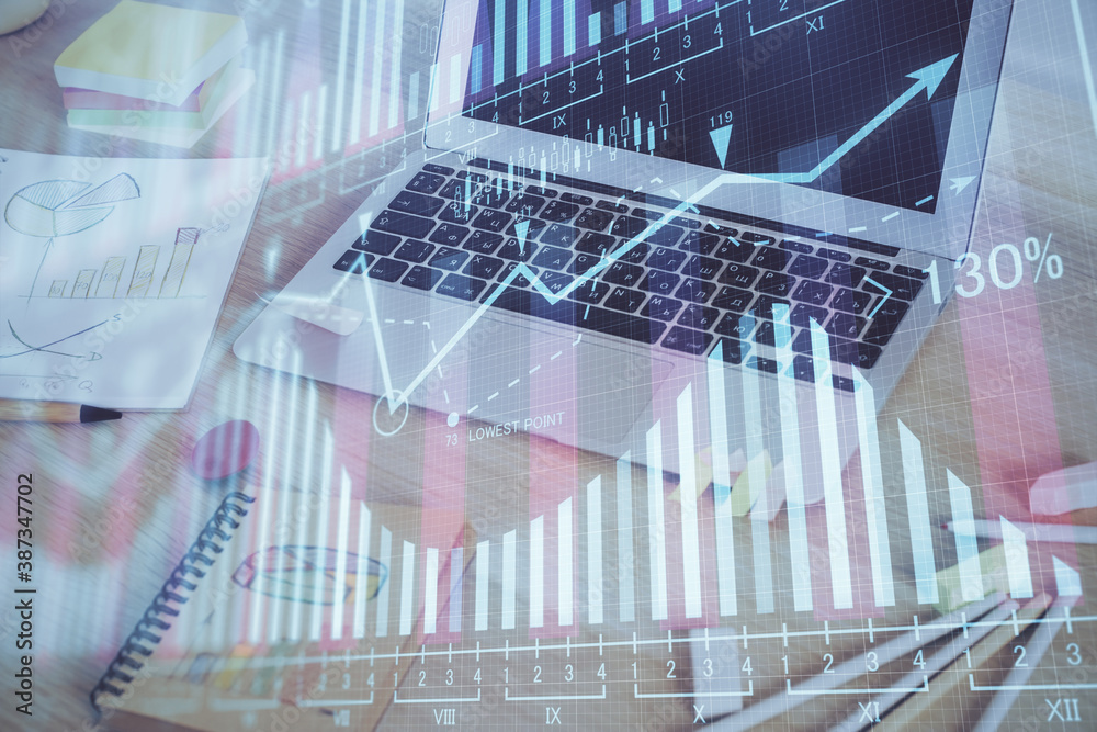 Obraz premium Financial chart drawing and table with computer on background. Multi exposure. Concept of international markets.