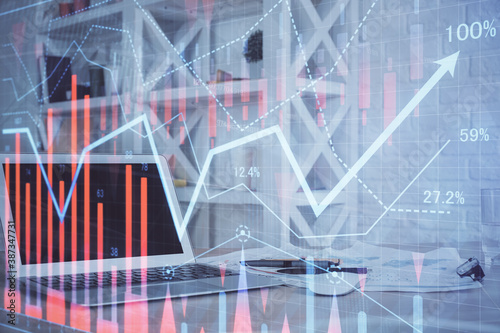 Stock market graph and table with computer background. Double exposure. Concept of financial analysis.