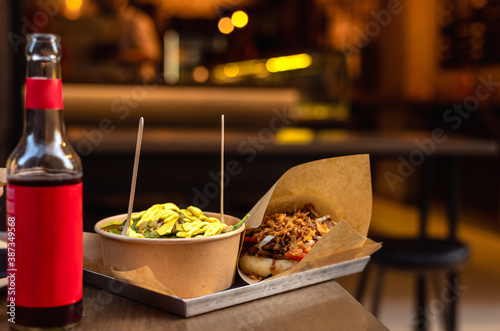 Taiwanese street fine cuisine. Salad with cinoa in bowl and pork gua bao photo