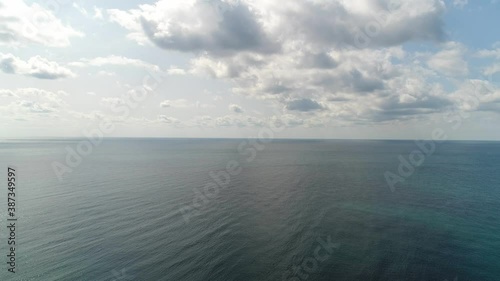 Aerial: a view from a height of the sea against the backdrop of a cloudy sky