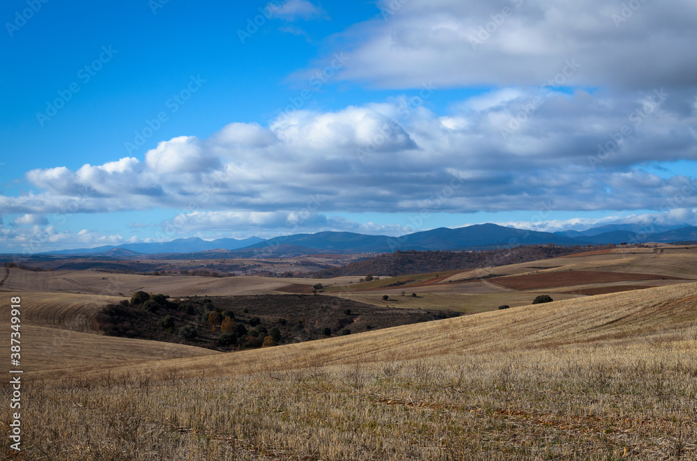 Landscape of the dry Castilian fields with a cloudy blue sky in winter, Atienza, Guadalajara, Spain