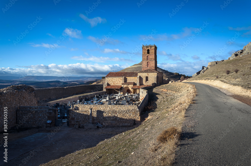 The church of Santa Maria del Rey with the annexed cemetery on a blue day with clouds, Atienza, Guadalajara, Spain