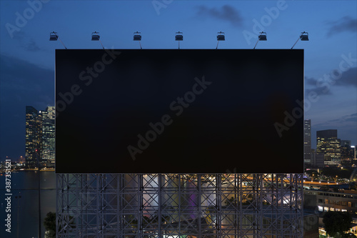 Blank black road billboard with Singapore cityscape background at night time. Street advertising poster, mock up, 3D rendering. Front view. The concept of marketing communication to sell idea.