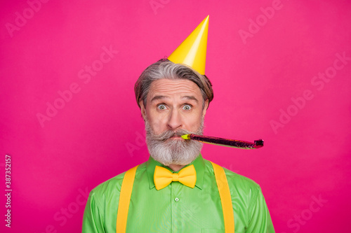 Tableau sur toile Photo of funny white haired grandpa blow noisemaker funky birthday party chillin