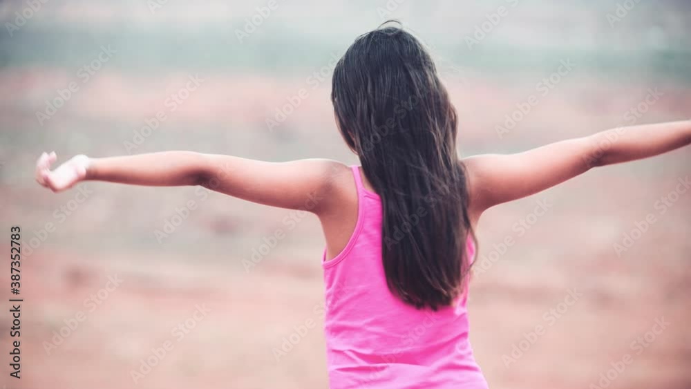 Young girl win open arms looking at panorama in national park Young girl win open arms looking at panorama in national park