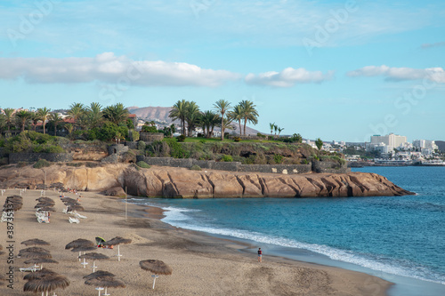 Views of Playa del Duque towards Las Americas coast, a popular beach visited by thousands of tourists yearly, but with only few people now due to the global lockdown, Tenerife, Canary Islands, Spain