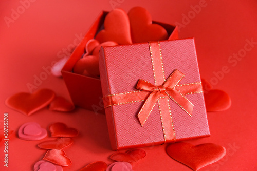 open heart-filled red gift box on red background. Love. Valentine's Day. Selective focus