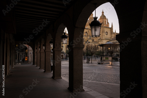View of the cathedral from the arcades of the Plaza Mayor in Segovia, Spain