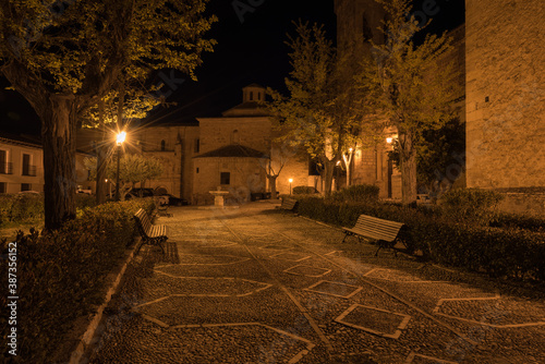 Cobblestone on the streets of Cifuentes with the church of Santo Domingo in the background at night, Guadalajara, Spain