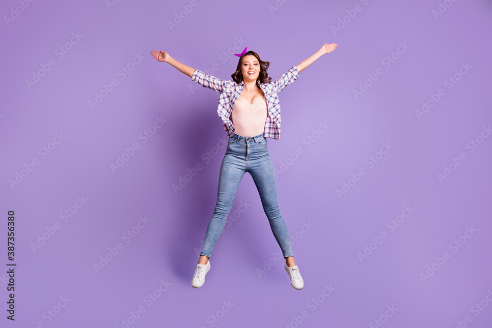 Full length photo portrait of sweet charming brown hair girl wear retro plaid shirt jumping isolated purple color background