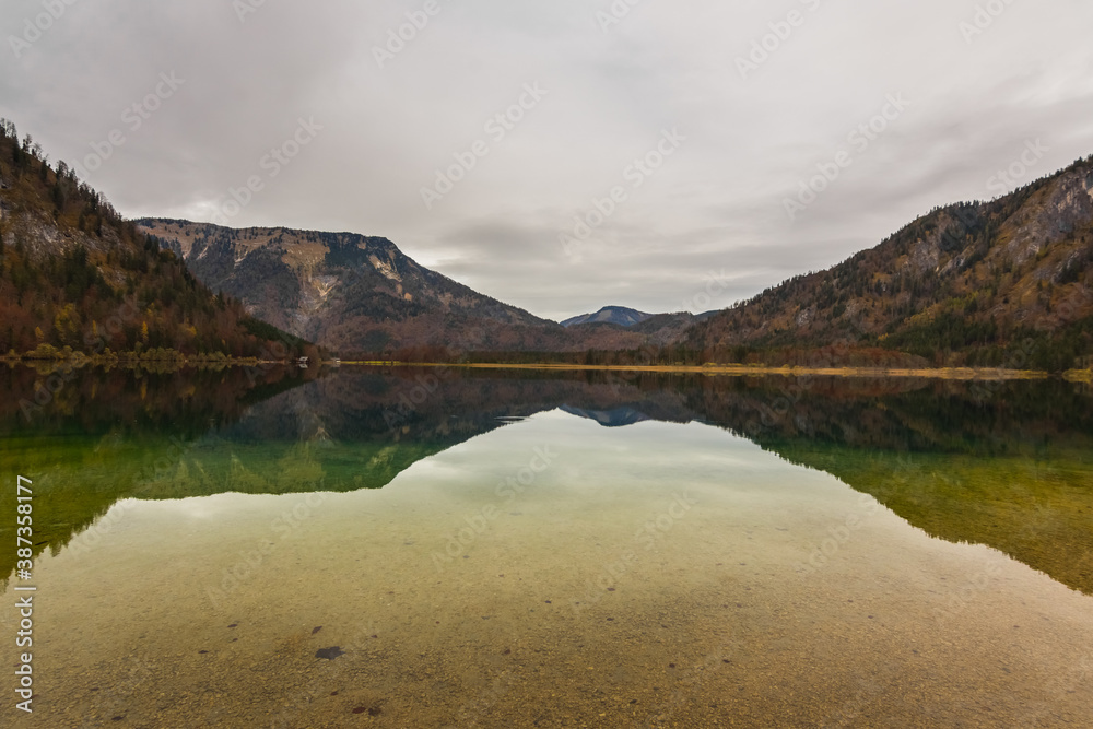 mountain landscape with lake while hiking in autumn with rain and clouds