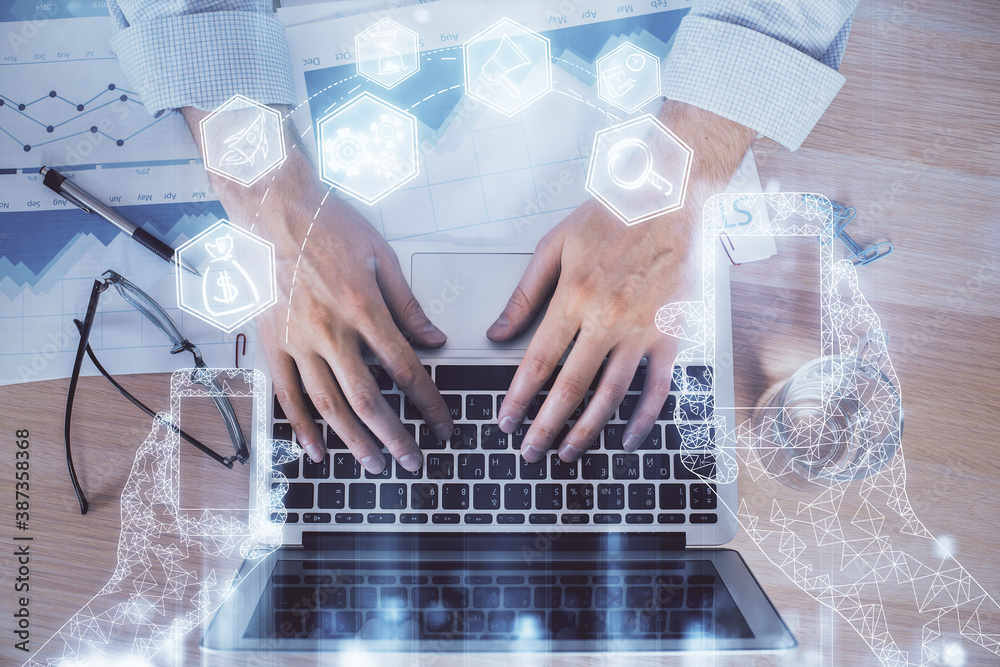 Technology theme hologram with man working on computer on background. High tech concept. Double exposure. Technology theme hologram with man working on computer on background. High tech concept. Double exposure.