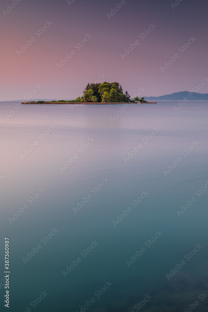 Portrait view of Mouse Island, Corfu, Greece, at sunrise. Showing the clear Mediterranean sea in the foreground