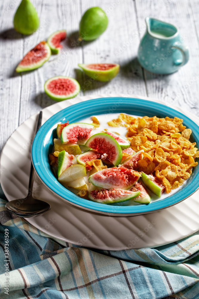Blue bowl with yogurt, cornflakes, figs, pear Blue bowl with yogurt, cornflakes, figs, pear