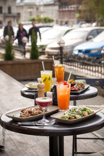 lunch dishes and cocktails served on the table street food cafe summer outside