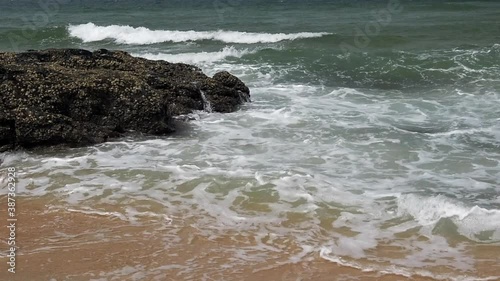 Slow motion footage of tropical sandy beach under bright sunny day