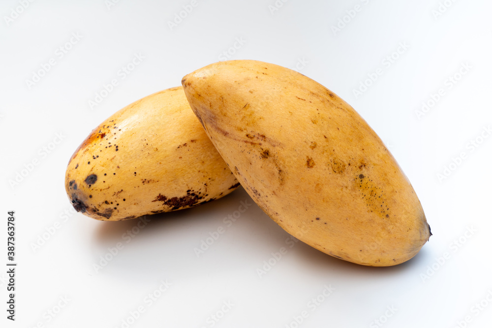 Disease mango on a white background, a black spot on the surface of the mango is often referred to as anthracnose. Disease mango on a white background, a black spot on the surface of the mango is often referred to as anthracnose.