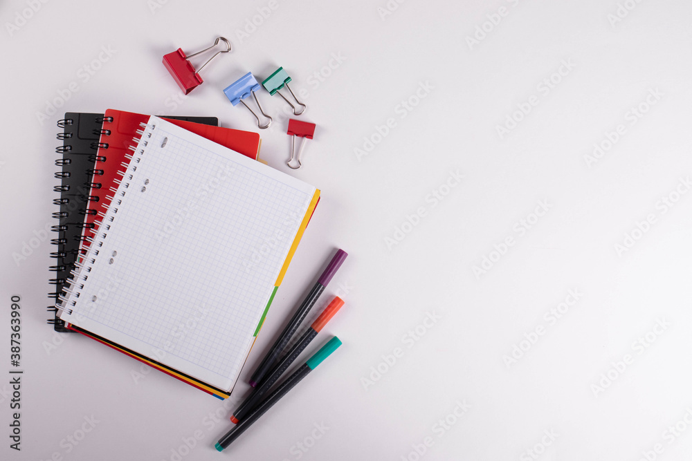 different stationary items of various colours on light surface. different stationary items of various colours on light surface.