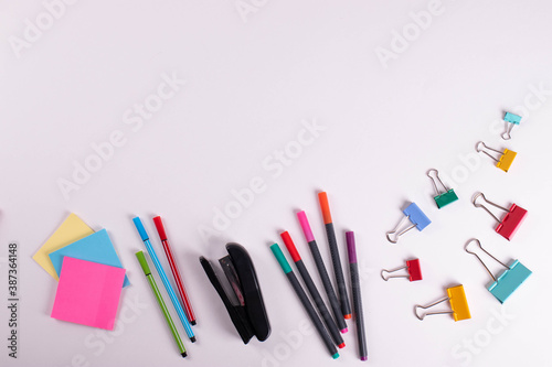 different stationary items of various colours on light surface.