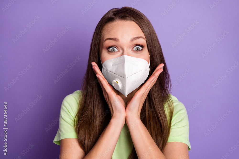 Photo portrait of excited girl with hands near face wear respirator isolated on vivid purple colored background Photo portrait of excited girl with hands near face wear respirator isolated on vivid purple colored background