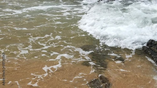 Slow motion footage of tropical sandy beach under bright sunny day