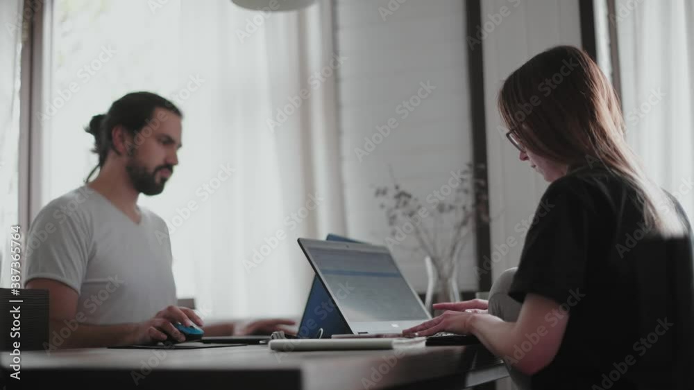 A young couple in love working together on a computer, safely from home. A young couple in love working together on a computer, safely from home.
