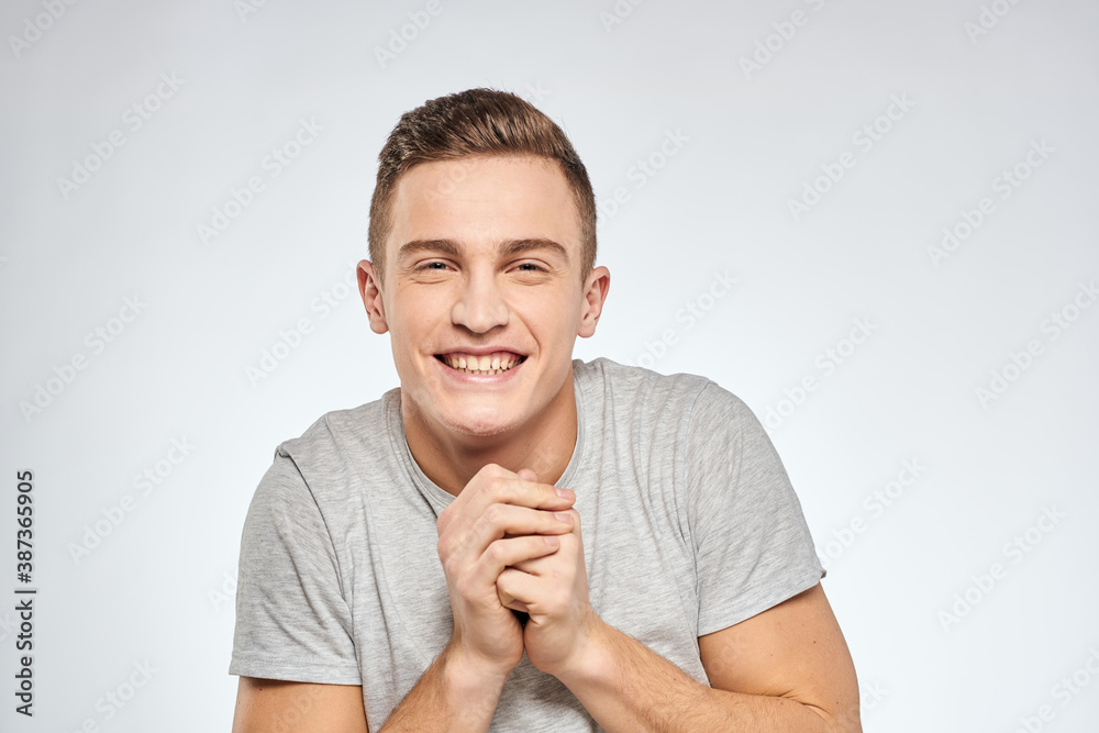 man in gray t-shirt emotions light background cropped view man in gray t-shirt emotions light background cropped view