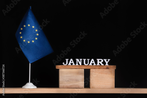 Wooden calendar of January with flag EU on black background. Holidays of European Union in January