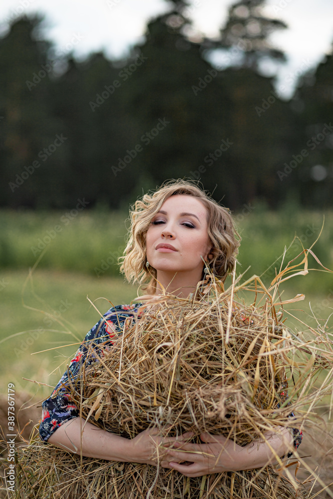 young attractive girl in a dress in a rustic style. Portrait of a beautiful romantic young woman in the countryside at sunset. young attractive girl in a dress in a rustic style. Portrait of a beautiful romantic young woman in the countryside at sunset.