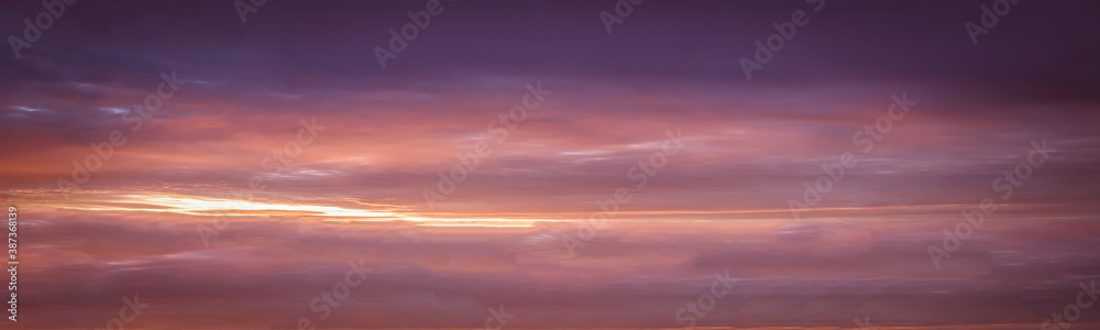 Panoramic background of dangerous cloud scene in the sunset sky Multicolored sky with clouds in the sunset
