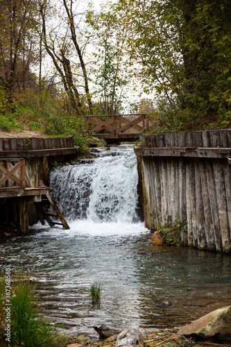 Small waterfall and small clear pond, inside the forest