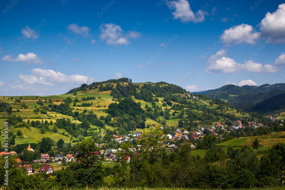 Mountain Bucznik and village Lomnica-Zdroj in summer. Beskid Sadecki, Poland.