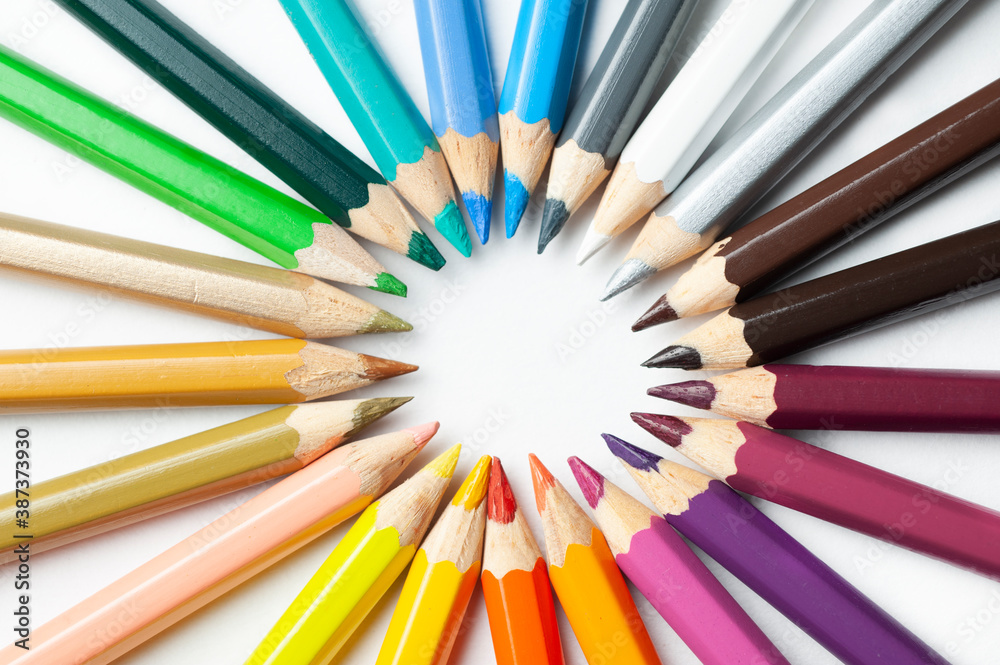 Naklejka premium a palette of pencils lies on a white background, top view