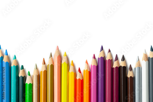 multicolored pencils lie on a white background