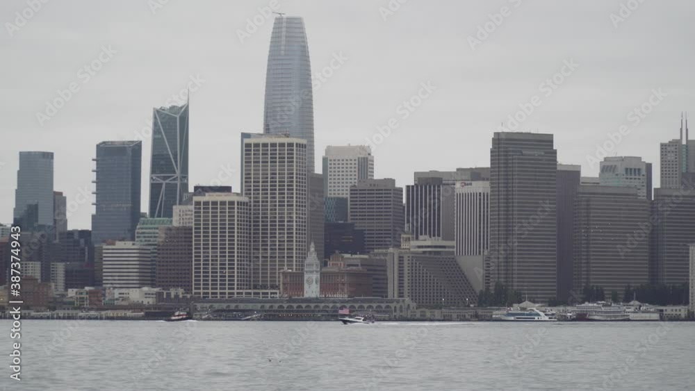 Patriotic Boat Sails Through the San Francisco Bay with the Skyline Behind It. Patriotic Boat Sails Through the San Francisco Bay with the Skyline Behind It.