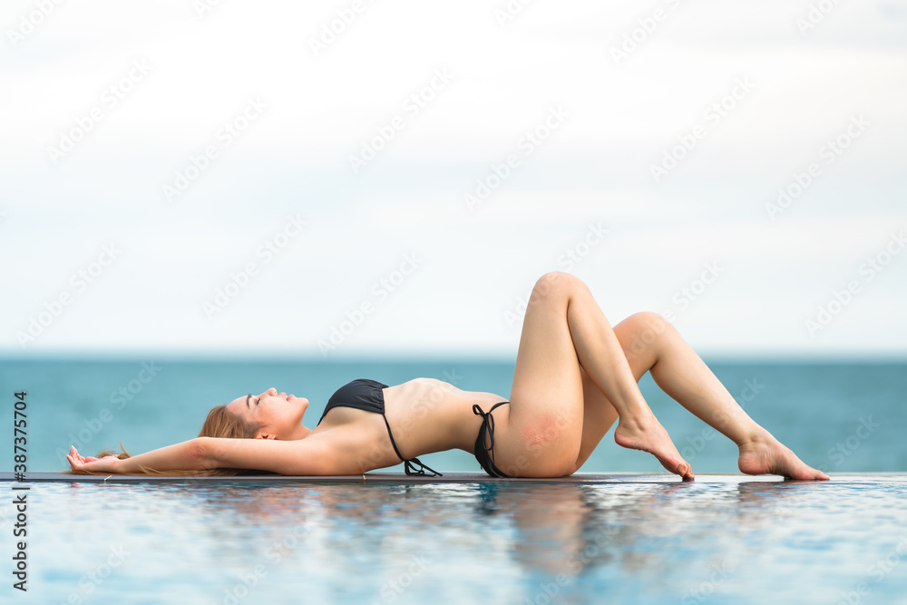 Beautiful Asian women or Thai women and black bikinis at the bar, relaxing at the beach for traveling in the summer concept Beautiful Asian women or Thai women and black bikinis at the bar, relaxing at the beach for traveling in the summer concept