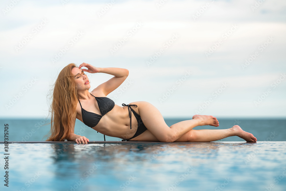 Beautiful Asian women or Thai women and black bikinis at the bar, relaxing at the beach for traveling in the summer concept Beautiful Asian women or Thai women and black bikinis at the bar, relaxing at the beach for traveling in the summer concept