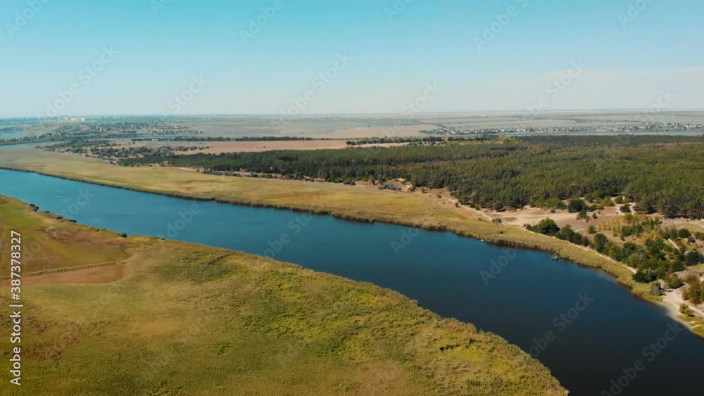 Aerial view of pine forest in Ukraine near river and few small villages on background. Beautiful nature landscape Aerial view of pine forest in Ukraine near river and few small villages on background. Beautiful nature landscape