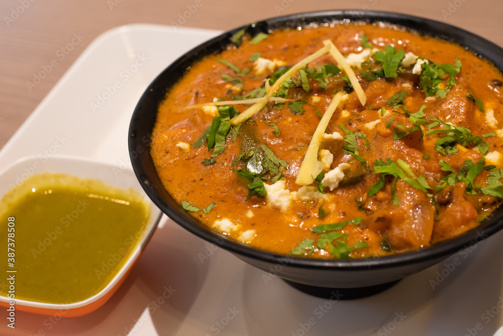 traditional Indian food, stewed vegetables with curry and paneer cheese, coriander sour sauce, food for vegans and vegetarians, garnished with grated ginger and cilantro leaves traditional Indian food, stewed vegetables with curry and paneer cheese, coriander sour sauce, food for vegans and vegetarians, garnished with grated ginger and cilantro leaves