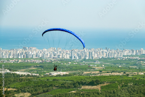 Exercises of paragliding athletes in the hills