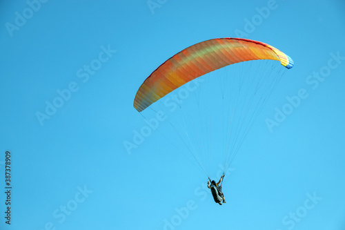 Exercises of paragliding athletes in the hills