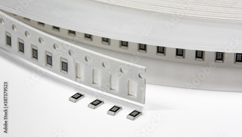 Close-up of tape with surface mount electronics components - resistors photo